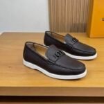 Dior men’s flat pebble – grain leather loafers with contrasting white rubber sole. Navy brown
