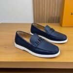 Dior men’s flat pebble – grain leather loafers with contrasting white rubber sole. Navy blue